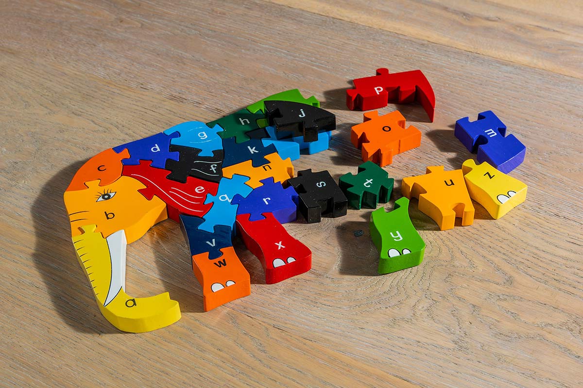 Alphabet Jigsaw handmade plastic free Elephant Alphabet wooden jigsaw in pieces laid out on a wooden floor