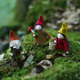 Close up of the Ambrosius handmade Autumn felt fairy figure collection stood on some green moss in the woods