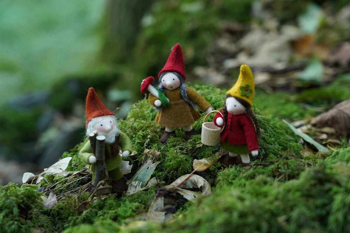 Close up of the Ambrosius handmade Autumn felt fairy figure collection stood on some green moss in the woods