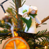 Ambrosius collectable christmas rose fairy figure in a christmas tree behind a slice of dried orange