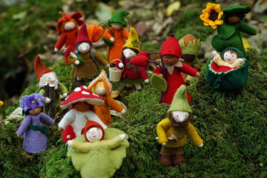 Close up of the Ambrosius handmade Autumn felt fairy figure collection stood on some green moss in the woods