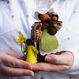 Close up of some hands holding the Ambrosius plastic-free mother earth and flower fairy figures