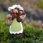 Close up of the Ambrosius eco-friendly mother earth and baby felt dolls stood on some moss