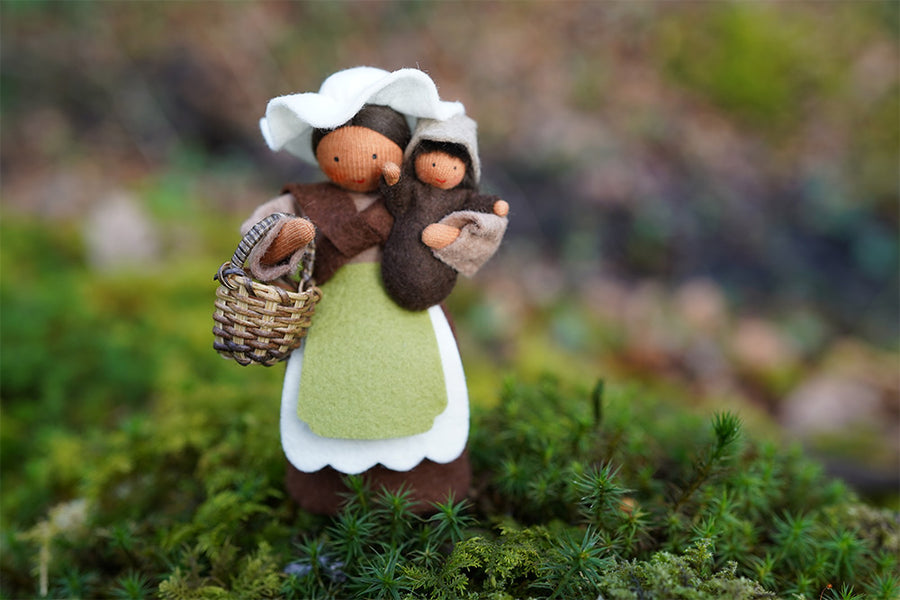 Close up of the Ambrosius eco-friendly mother earth and baby felt dolls stood on some moss