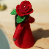 A close up of the red rose top on the Ambrosius felted fairy figure