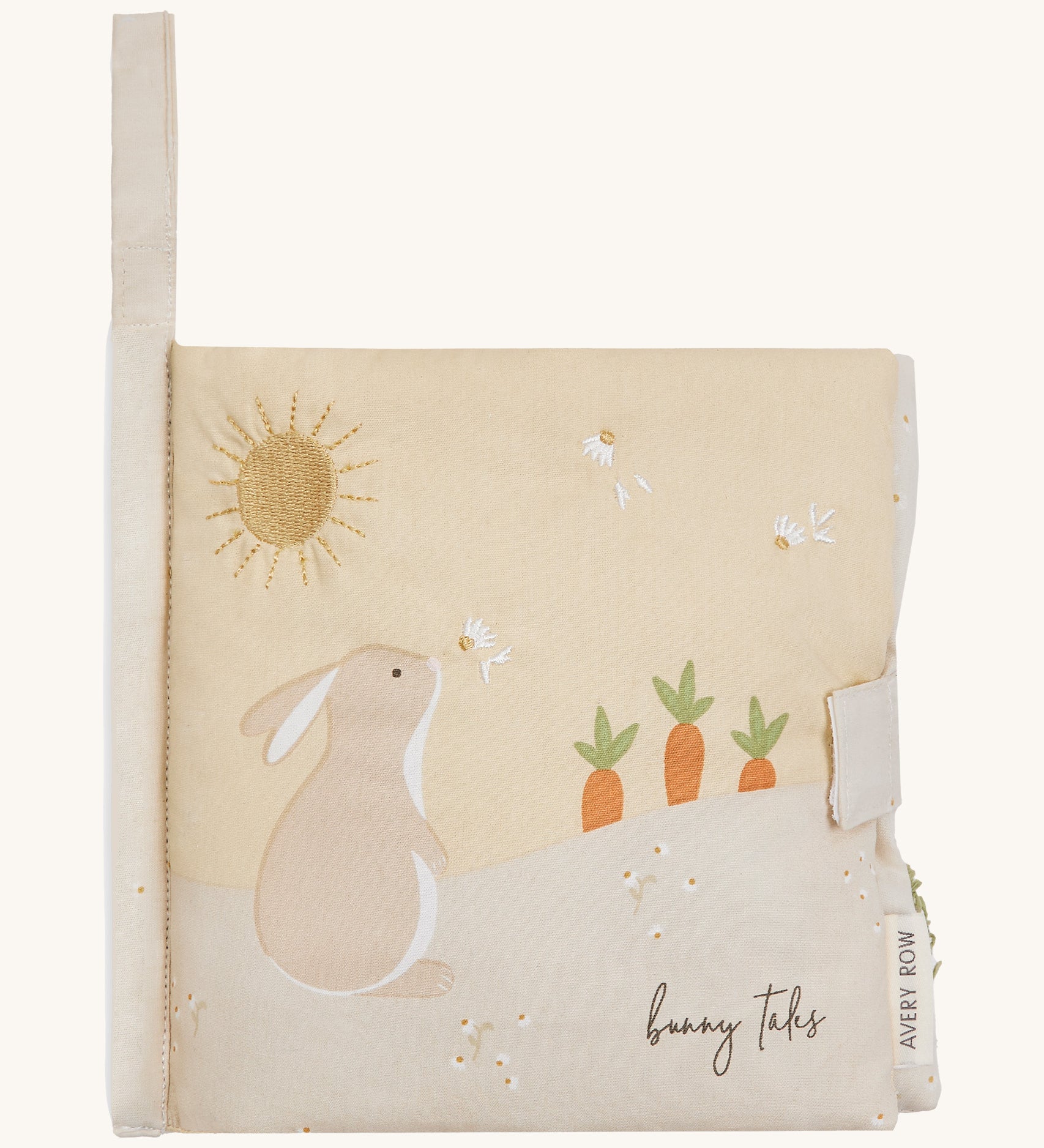 A soft beige Avery row baby book with a rabbit on the cover on a cream background.