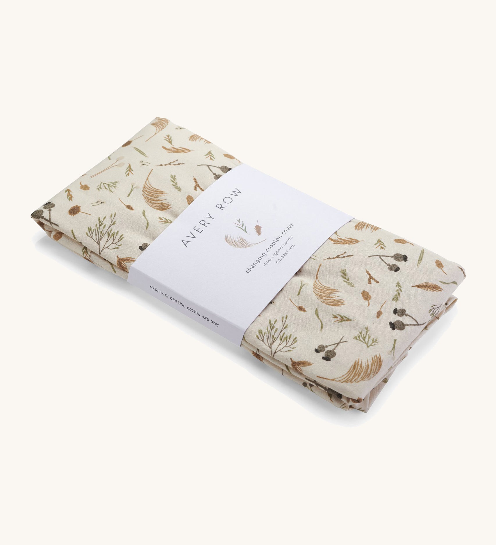 A light cream Avery Row long changing cushion cover with a grassland design on a cream background.