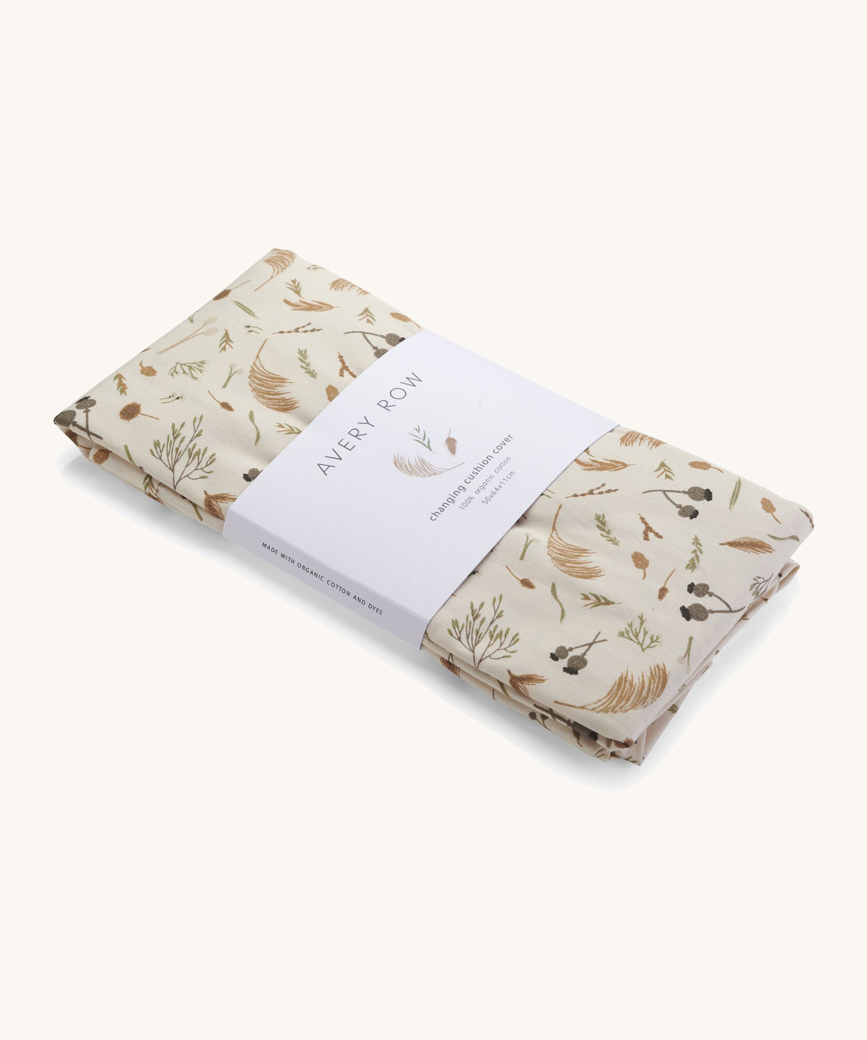 A light cream Avery Row long changing cushion cover with a grassland design on a cream background.