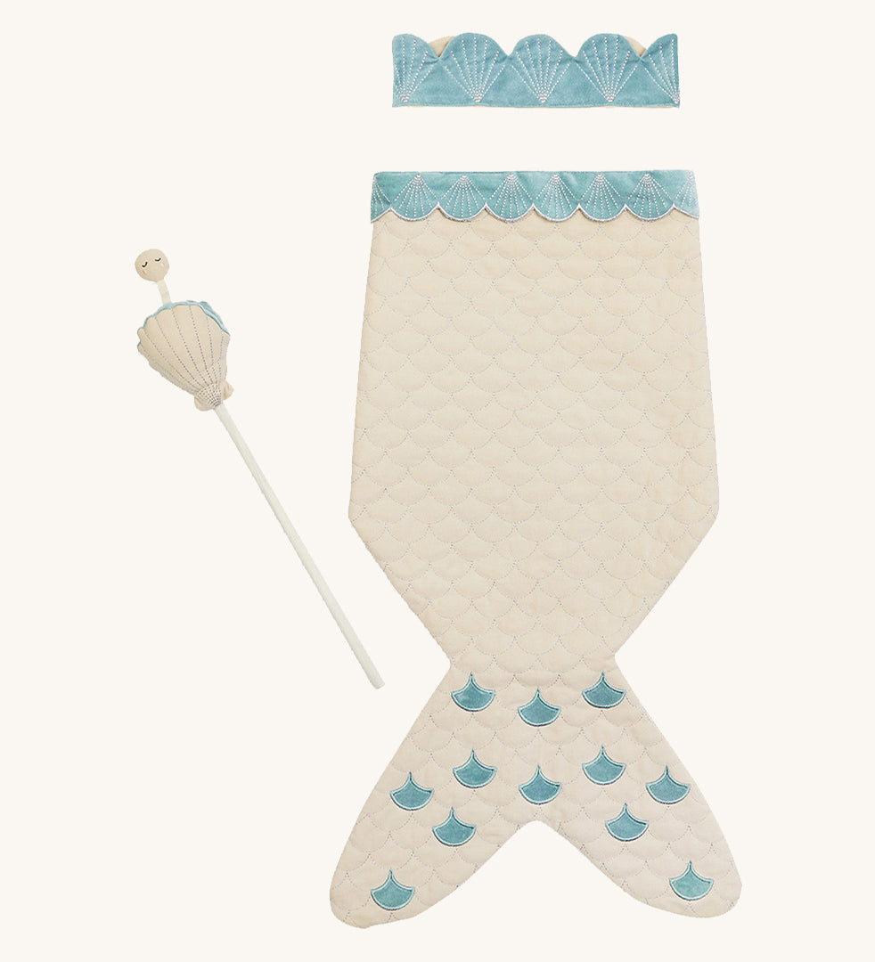 A light Avery row mermaid dress up set with a light blue trim including a light blue crown and a light shell wand on a cream background.