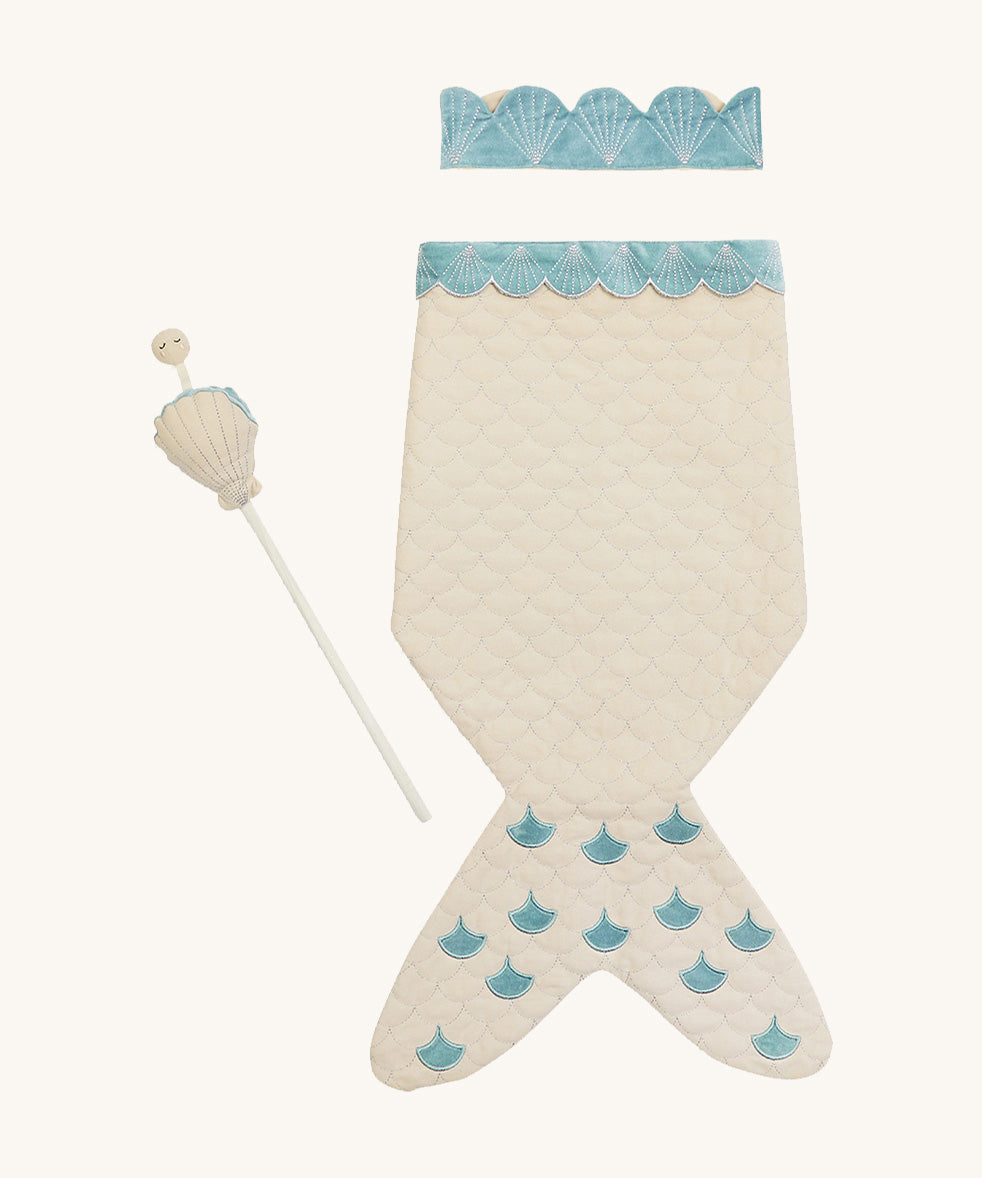 A light Avery row mermaid dress up set with a light blue trim including a light blue crown and a light shell wand on a cream background.