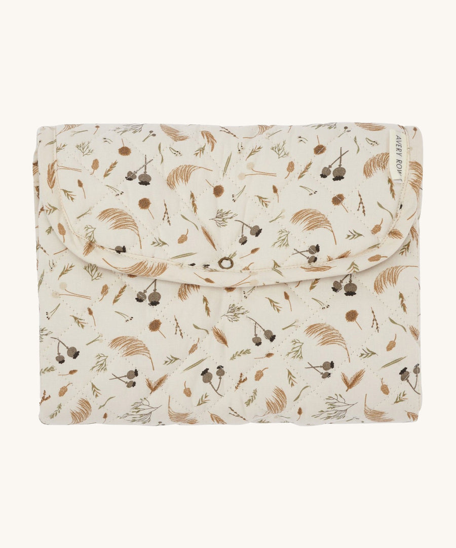 A light soft cream Avery Row travel changing mat with a grassland design on a cream background.