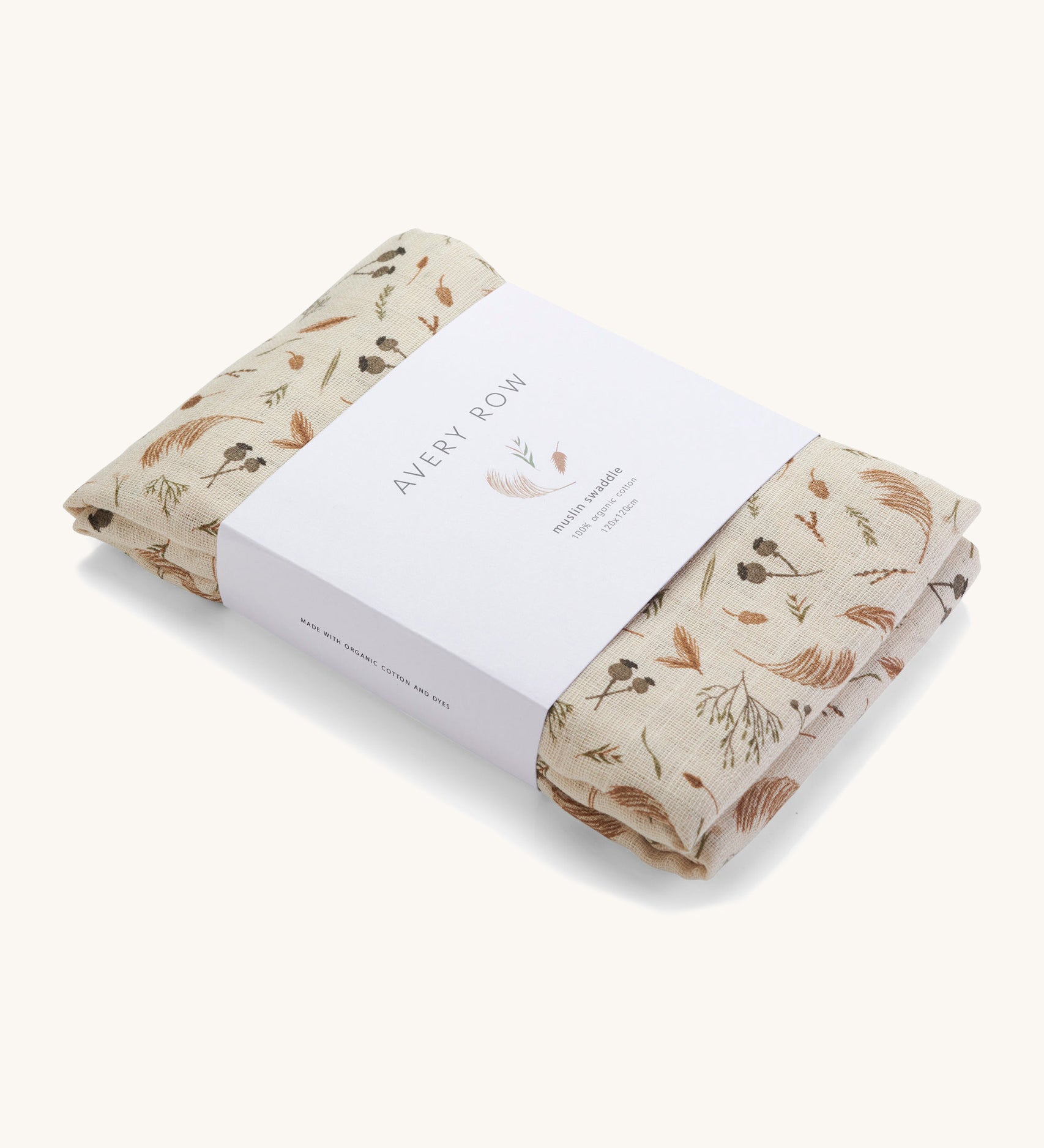 A light cream Avery Row muslin swaddle with a grassland design on a cream background.