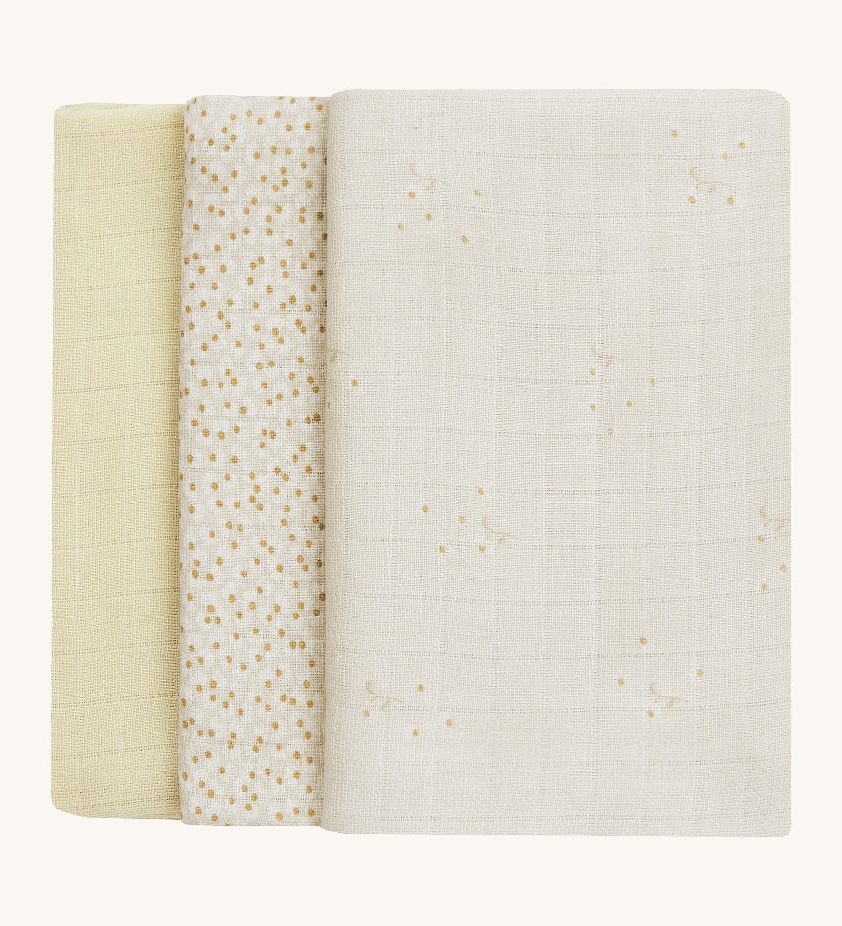 A soft light coloured Avery Row set of three muslin squares including a light with a wild chamomile design muslin, a daisy design and a light green muslin on a cream background.