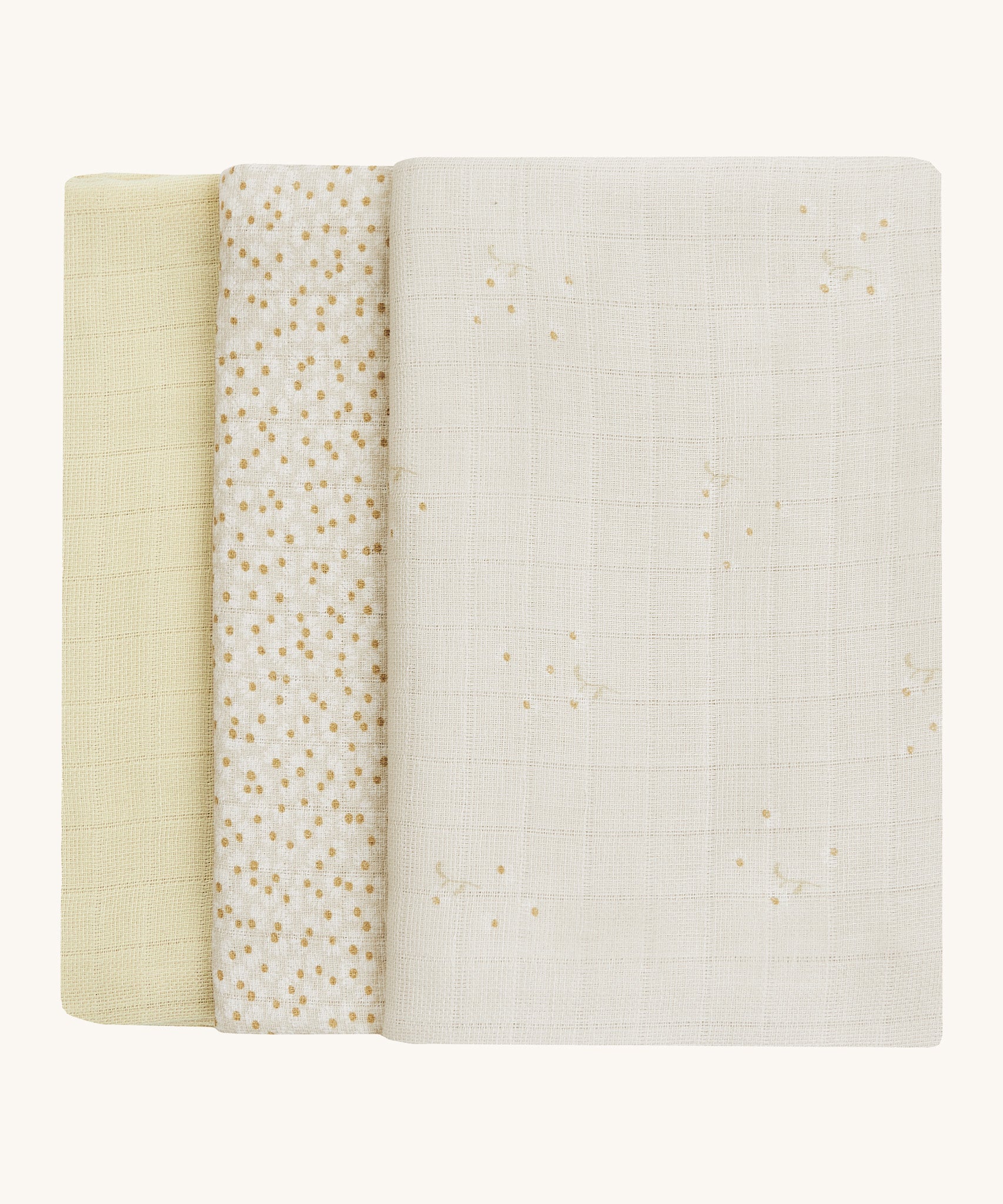 A soft light coloured Avery Row set of three muslin squares including a light with a wild chamomile design muslin, a daisy design and a light green muslin on a cream background.