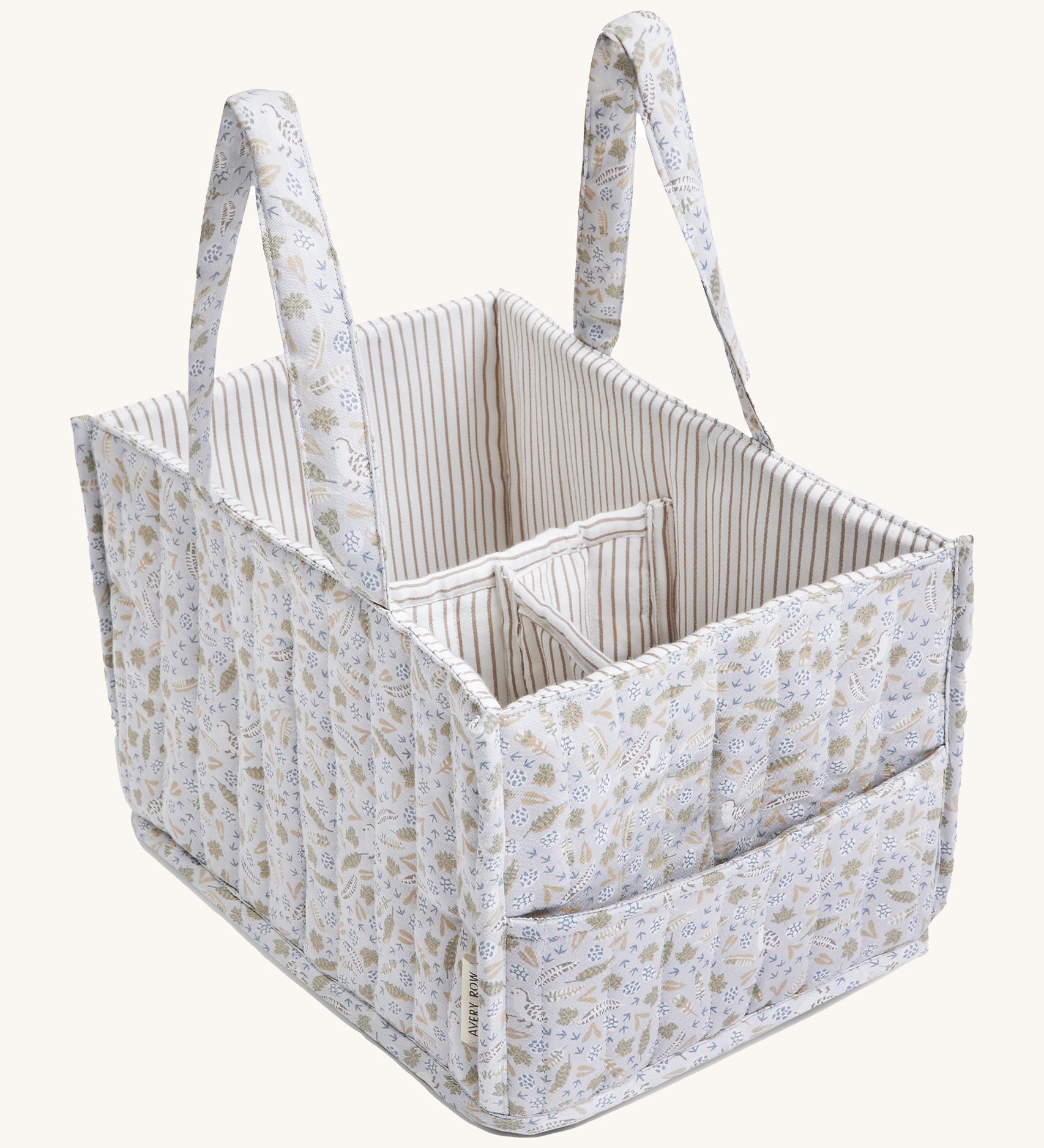 A soft light blue Avery Row nappy caddy organiser with a nature design on a cream background.