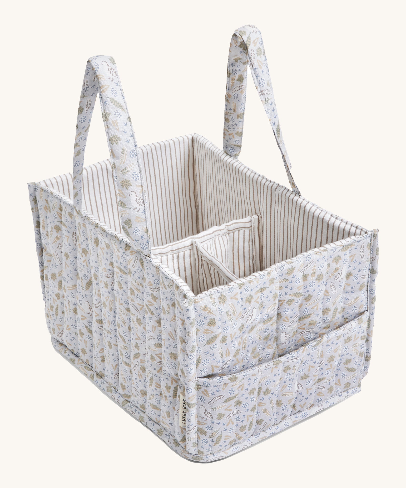 A soft light blue Avery Row nappy caddy organiser with a nature design on a cream background.