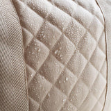 A close up of the water resistant quilted fabric on the outer of the Avery Row Baby Changing Bag in a  Natural colour