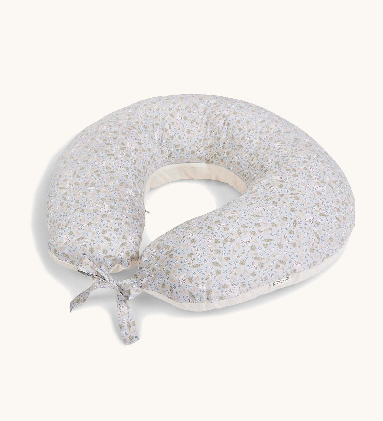 A soft light blue Avery Row nursing pillow with a nature design on a cream background.