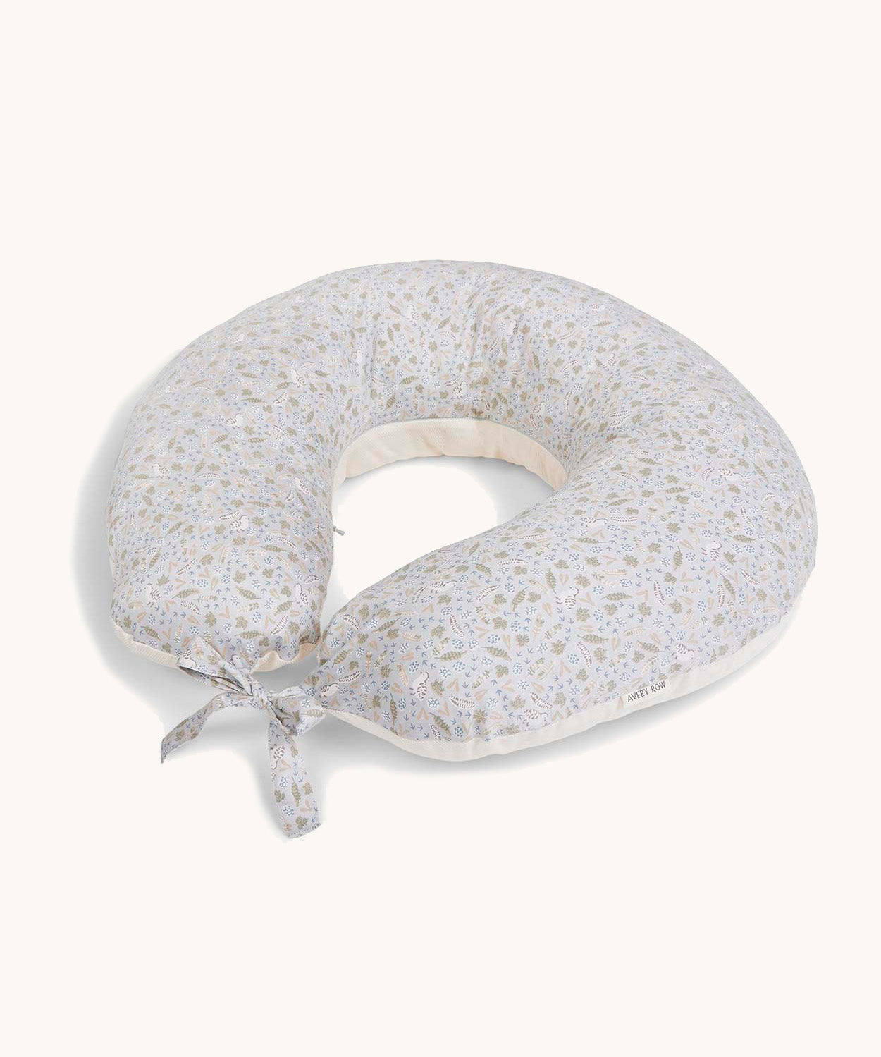 A soft light blue Avery Row nursing pillow with a nature design on a cream background.