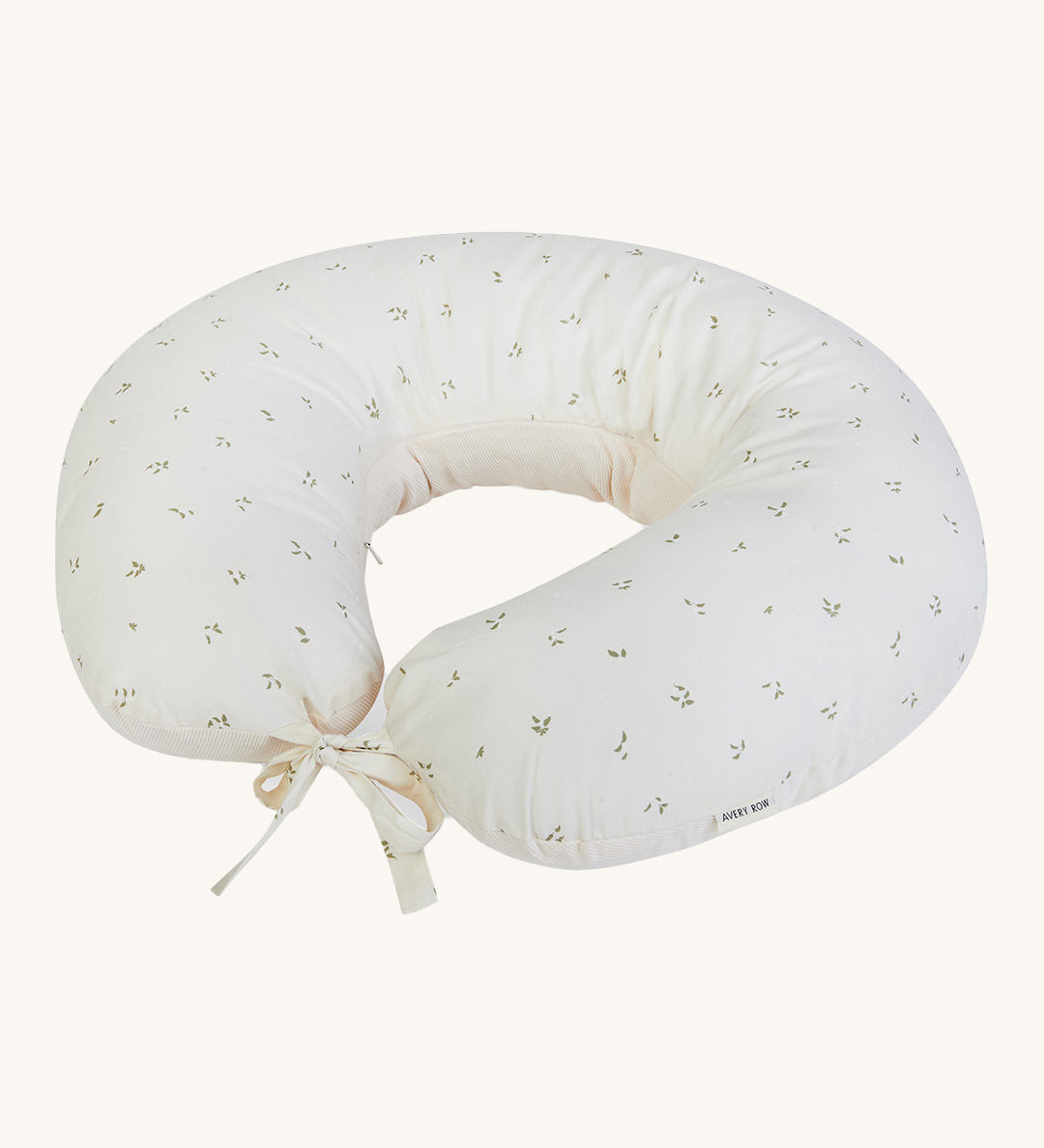 A soft light coloured Avery Row nursing pillow with a nettle design on a cream background.