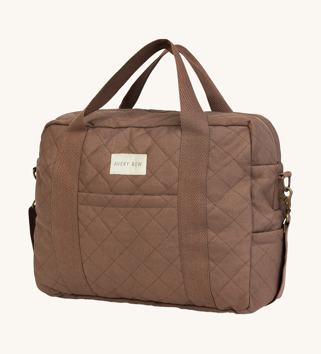 A brown nutmeg Avery Row baby changing bag on a cream background.