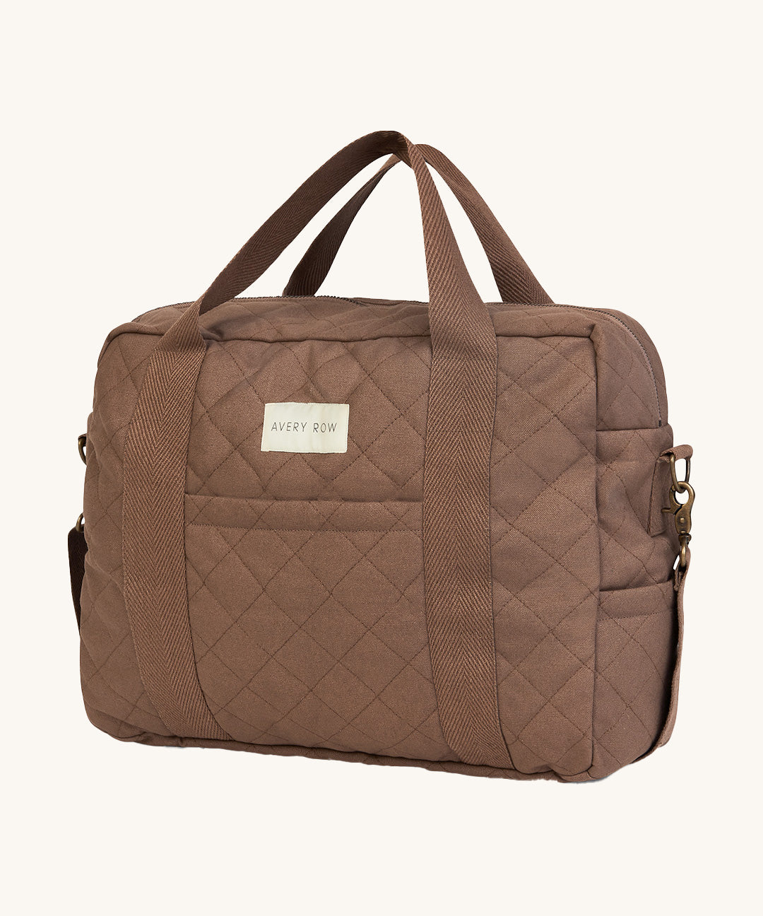 A brown nutmeg Avery Row baby changing bag on a cream background.