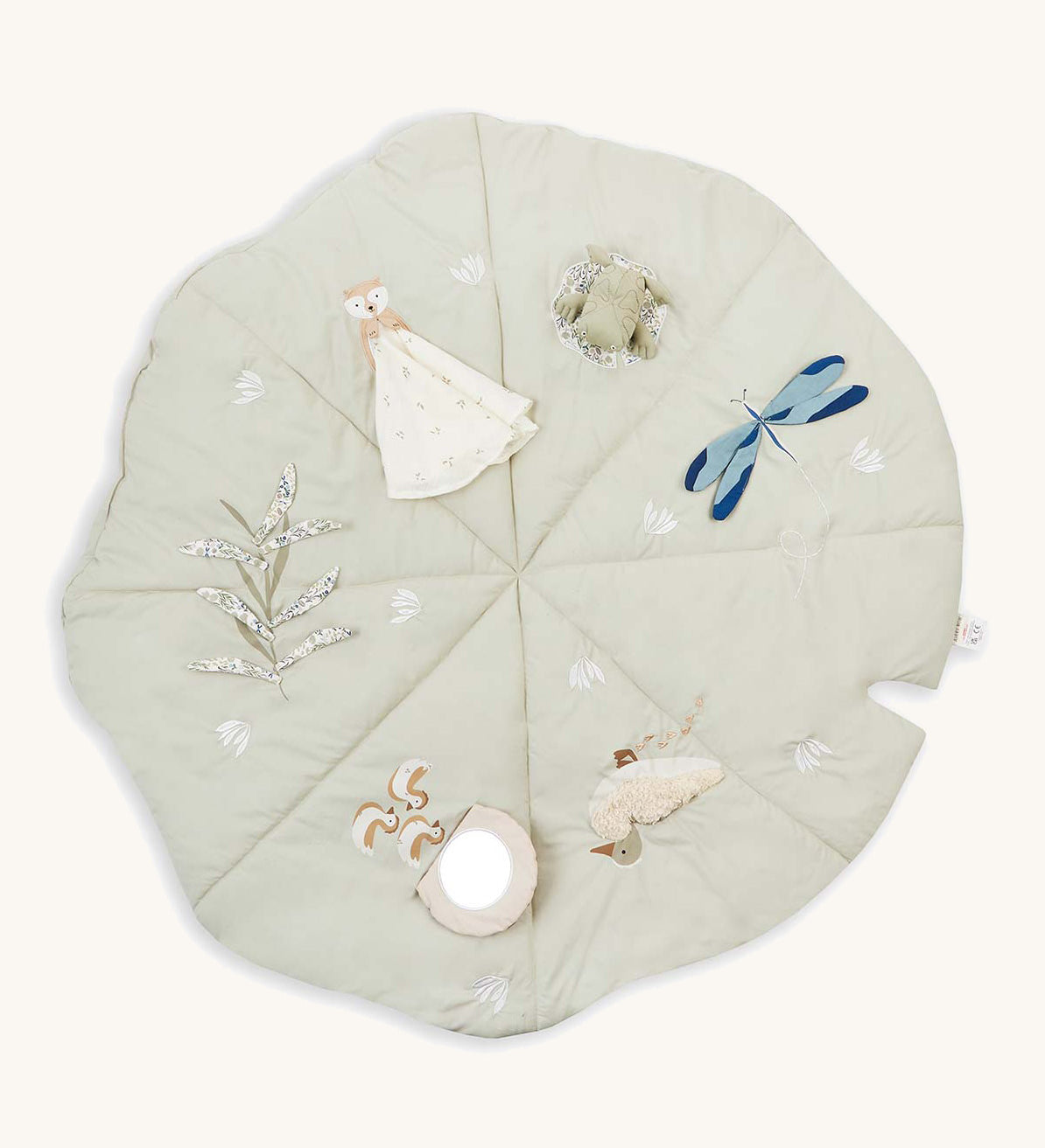 A soft light green Avery Row activity mat with a duck, dragonfly, frog, otter and flower on top of the mat on a cream background.