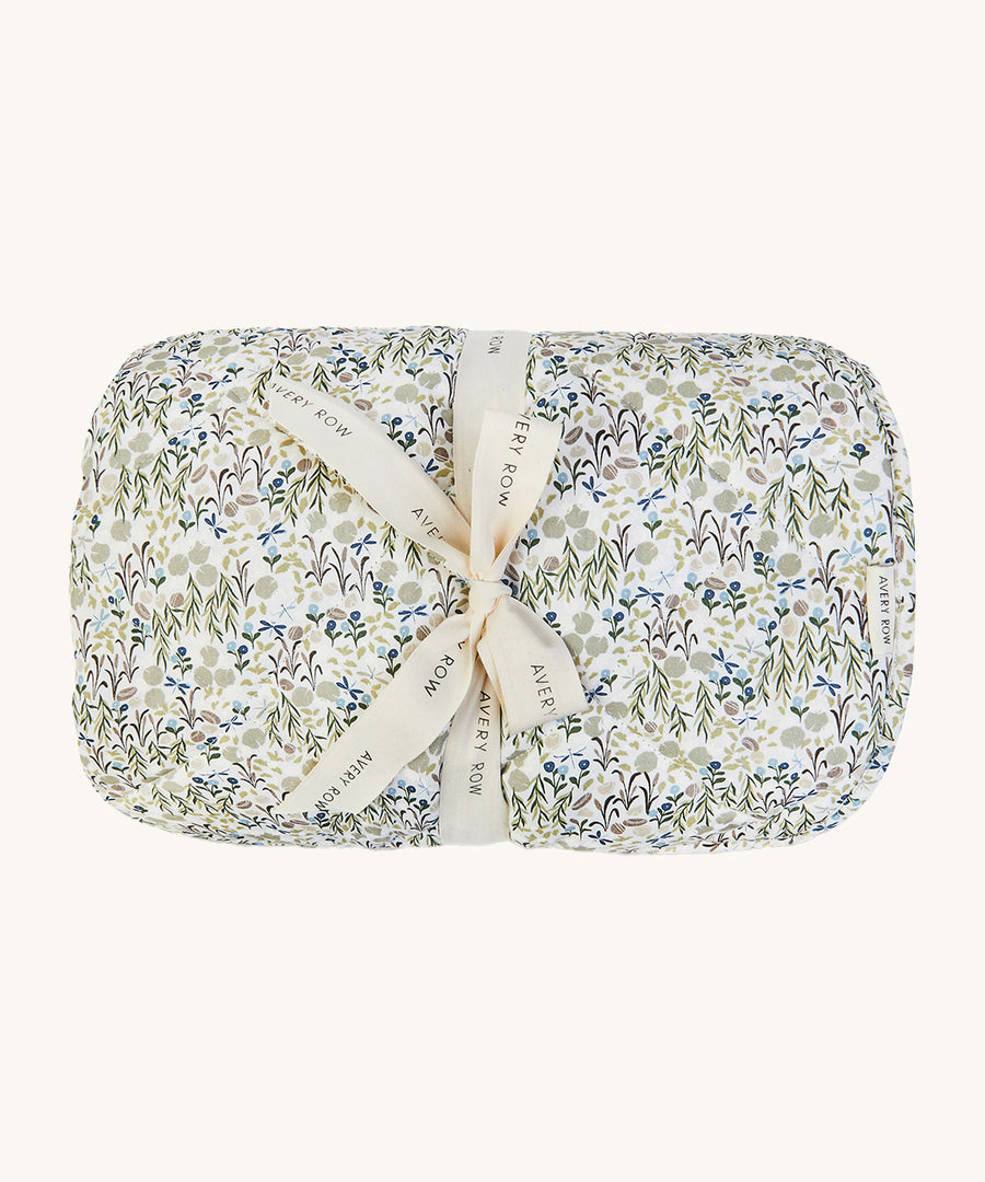 A soft Avery Row playmat with a flower design on a cream bakground.