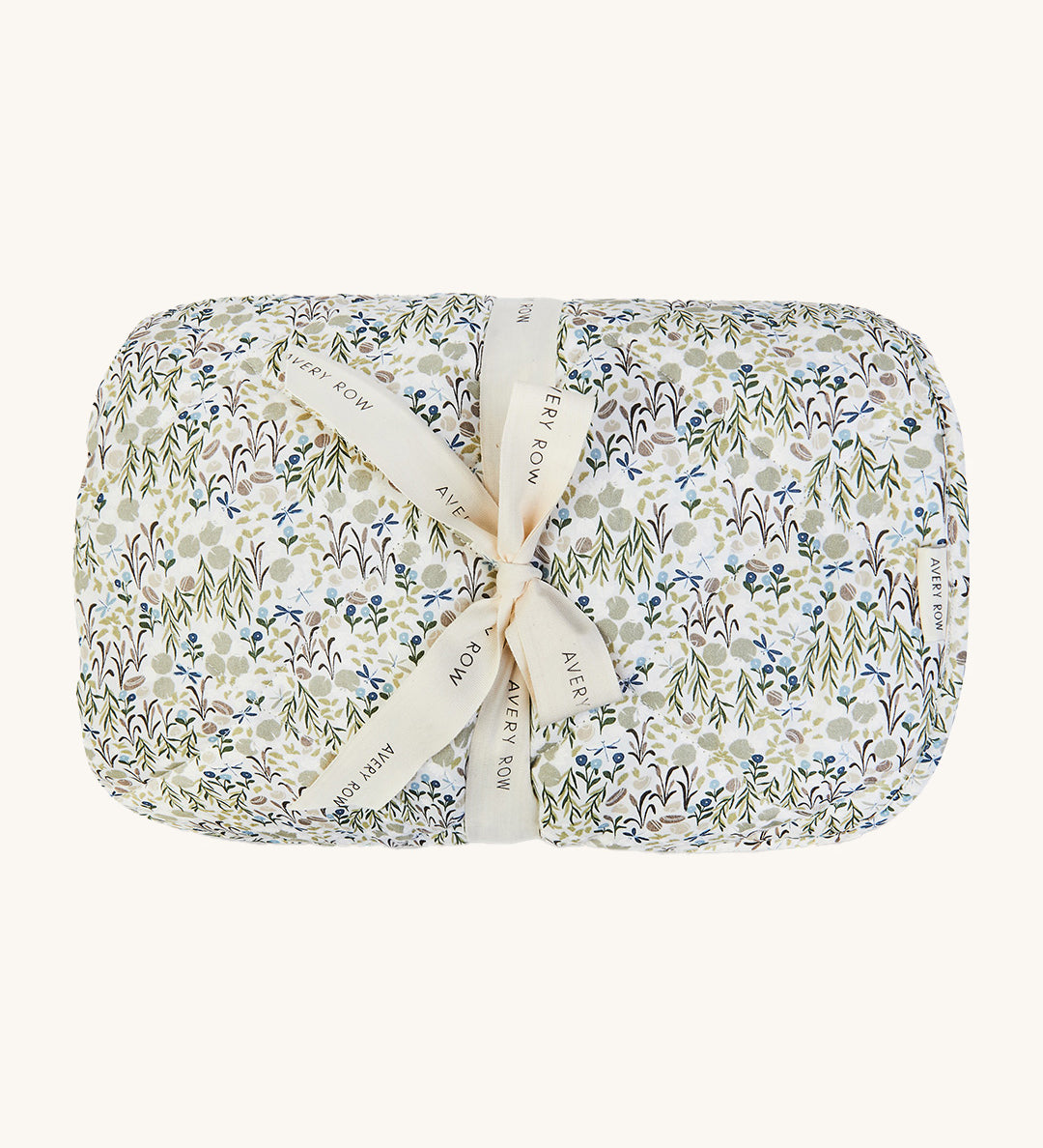 A soft Avery Row playmat with a flower design on a cream bakground.