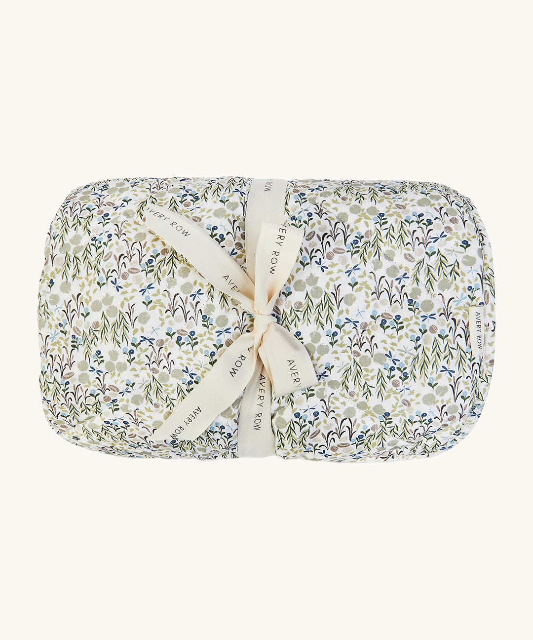 A soft Avery Row playmat with a flower design on a cream bakground.