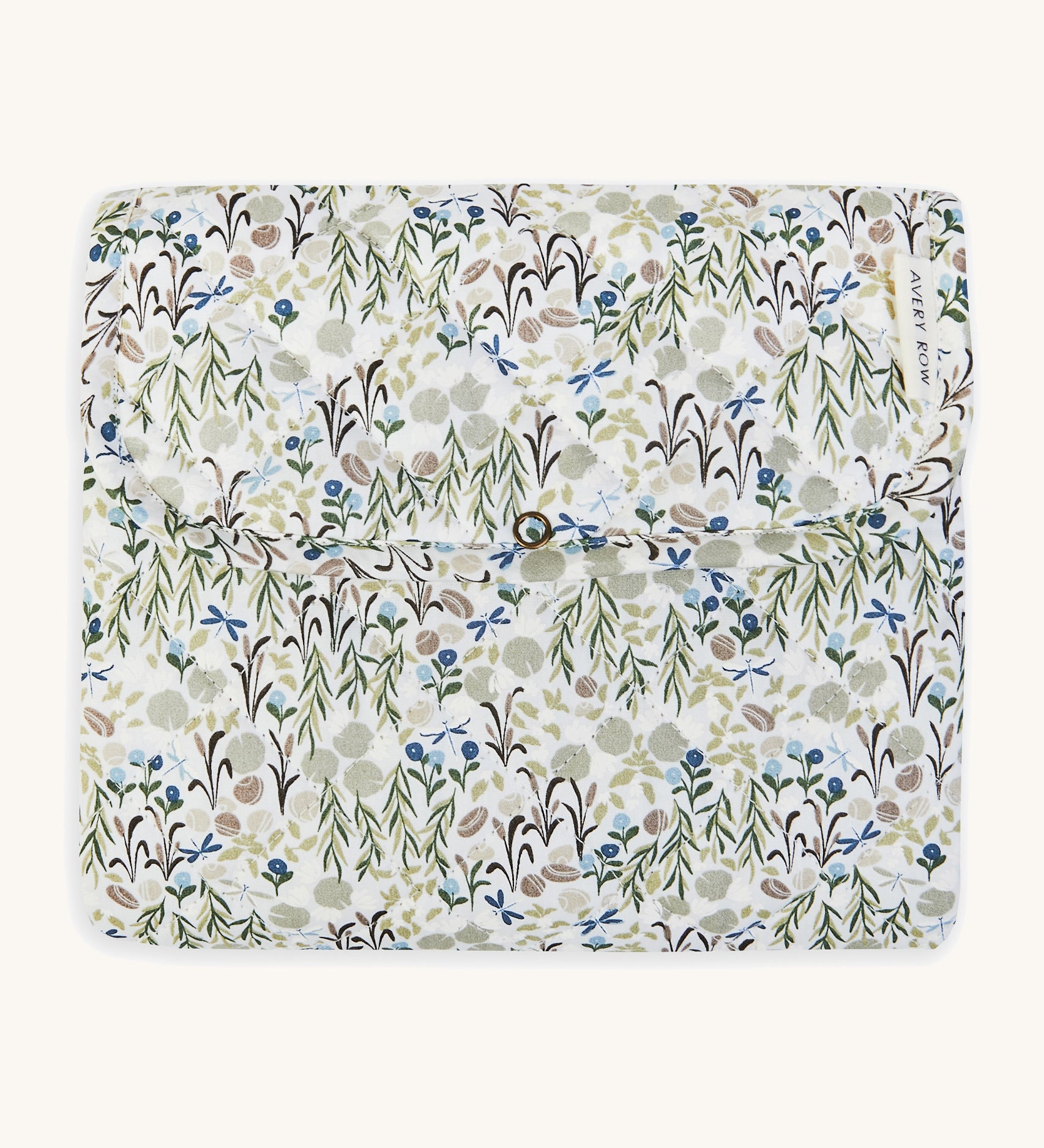 A soft Avery Row travel changing mat with a flower design  on a cream background.