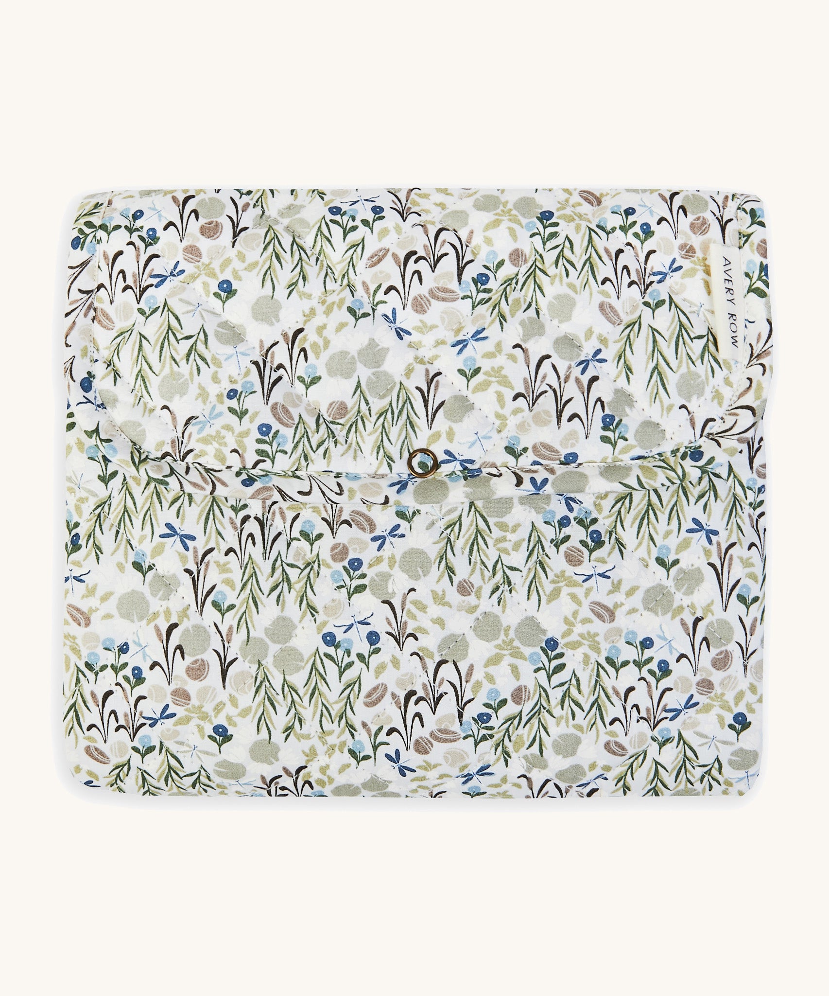 A soft Avery Row travel changing mat with a flower design  on a cream background.