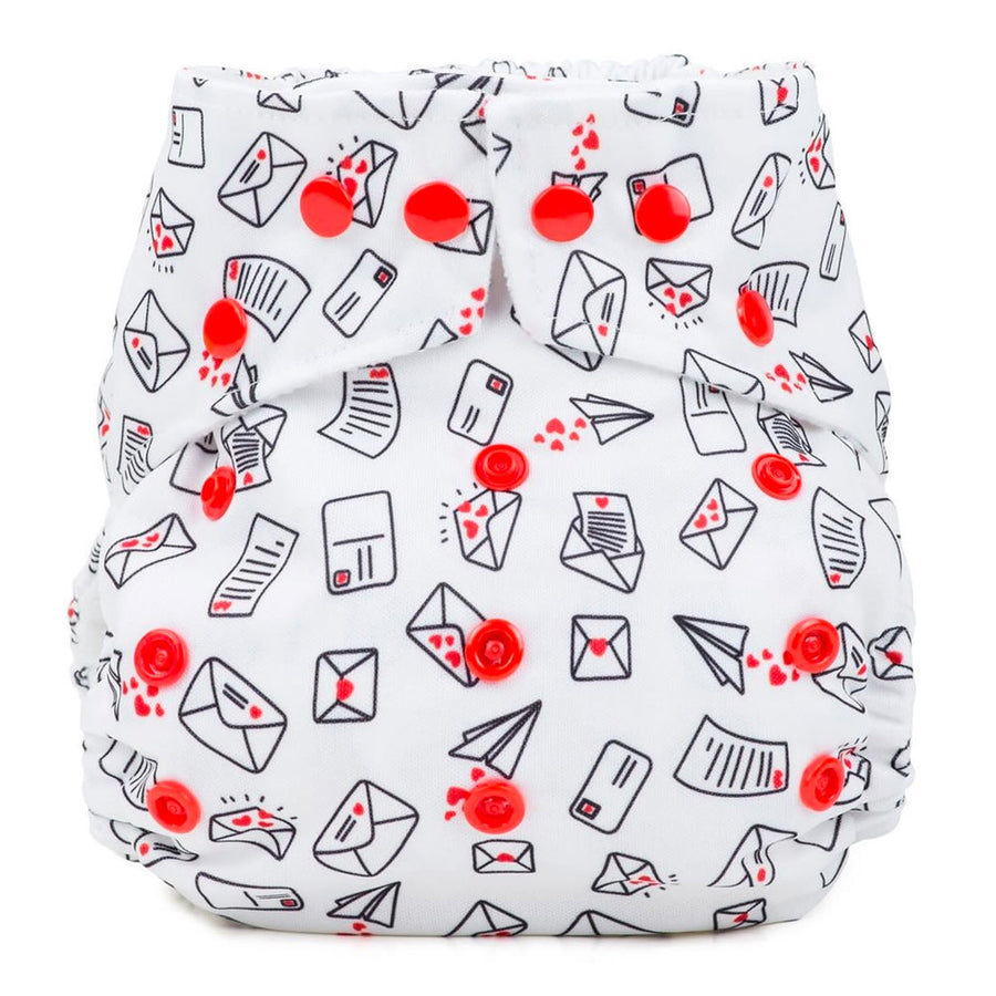 Baba & Boo Love Letters One-Size reusable nappy print is white with a hearts, envelopes and letter design with red poppers. White background.