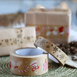 Babipur kraft eco paper tape in the Christmas decoration and snowflake prints on a green placemat in front of some Christmas presents