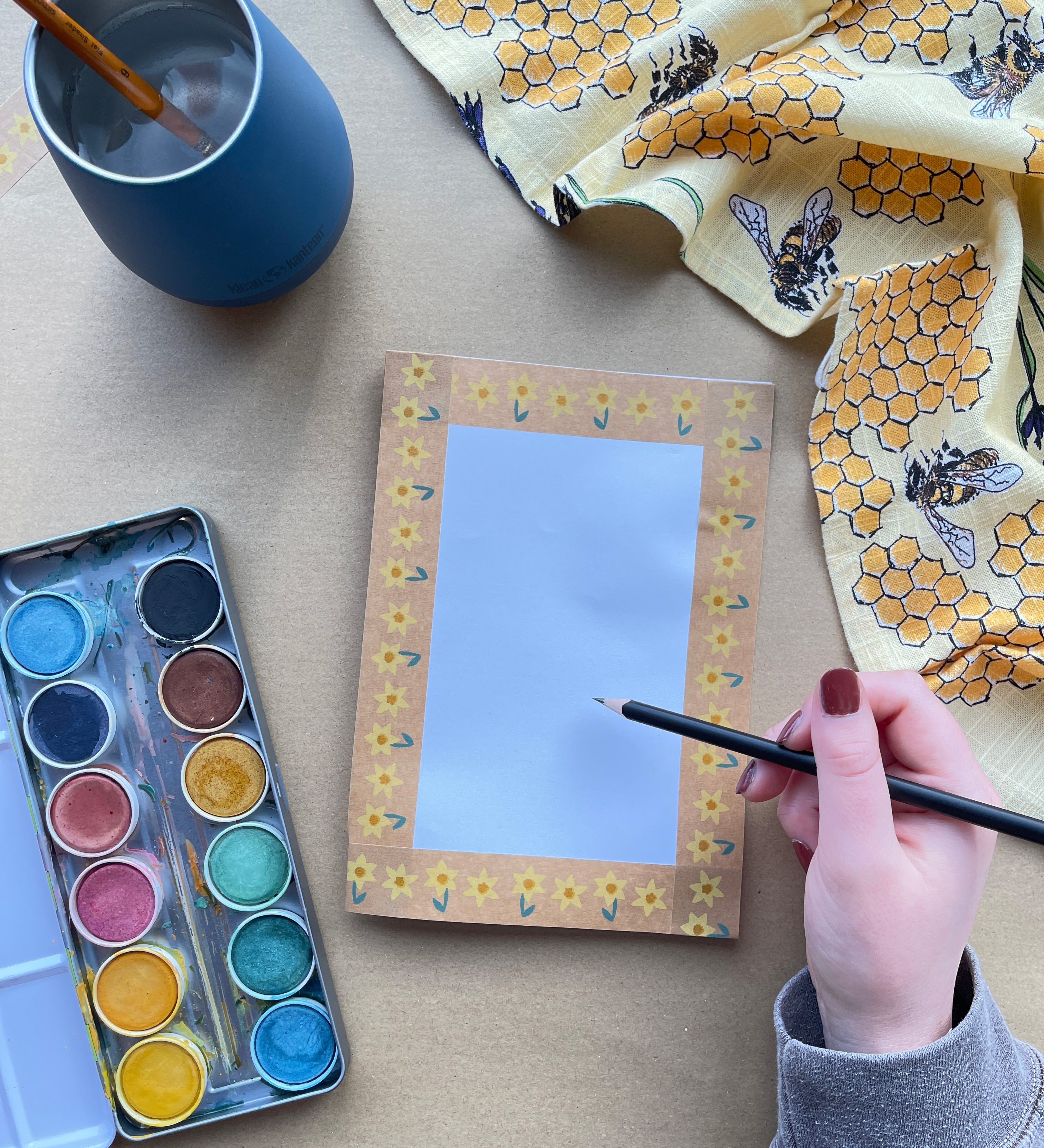 A closeup of an art table, with eco paints and Babipur eco paper craft paint.