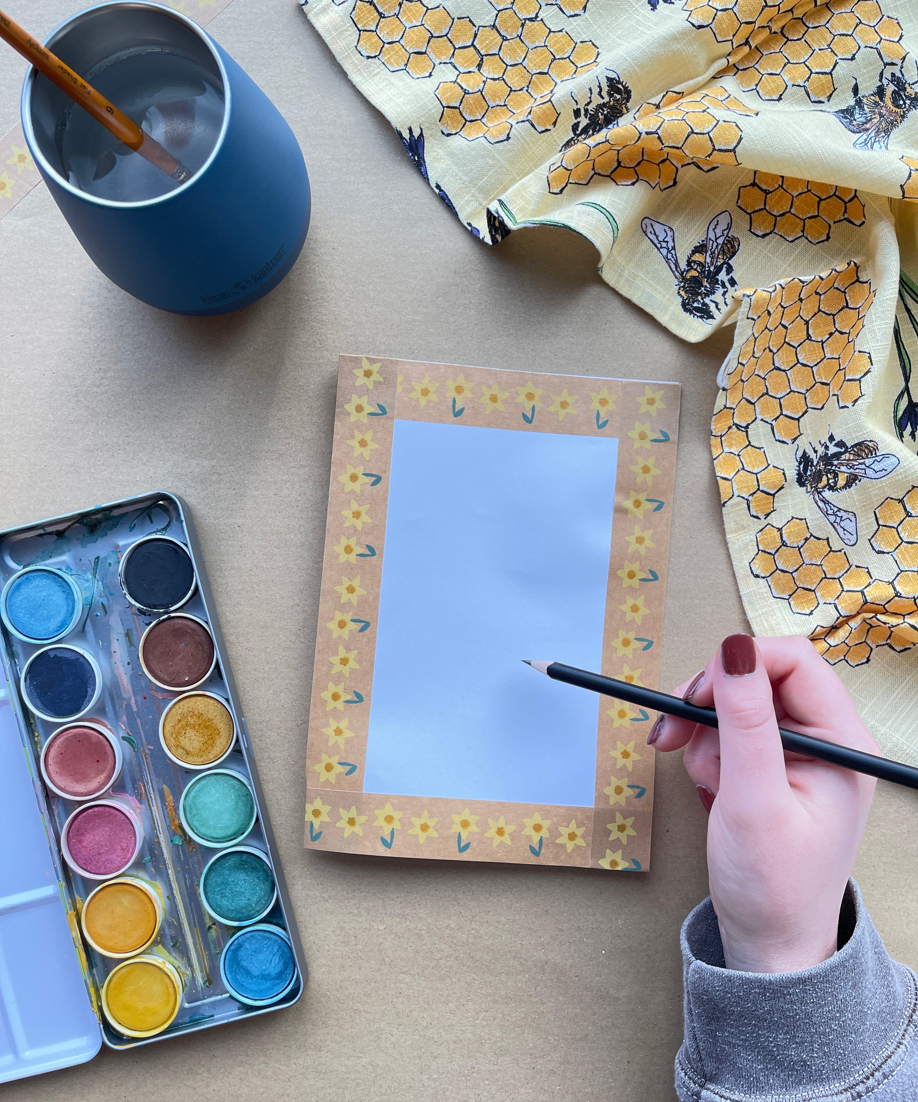 A closeup of an art table, with eco paints and Babipur eco paper craft paint.