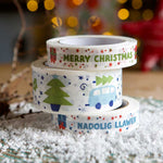 A stack of Christmas design babipur eco recyclable paper tapes. English Merry Christmas