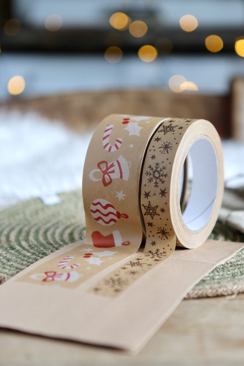 Babipur Christmas print eco kraft paper tapes stuck to some brown card in front of some Christmas lights