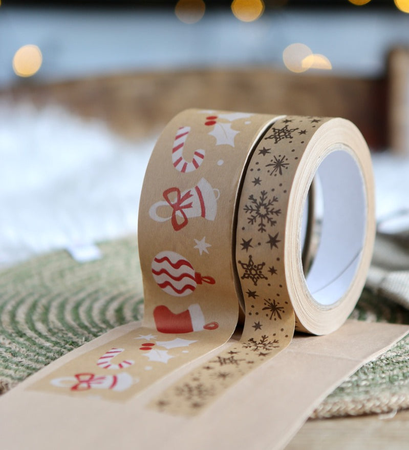 Babipur Christmas print eco kraft paper tapes stuck to some brown card in front of some Christmas lights