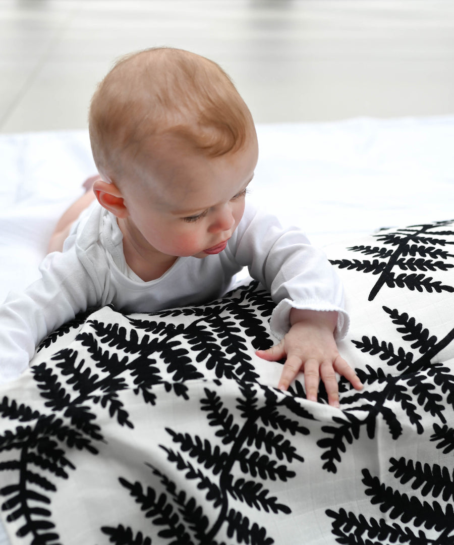  made from GOTS organic cotton with a black leafy fern print. On a cream background