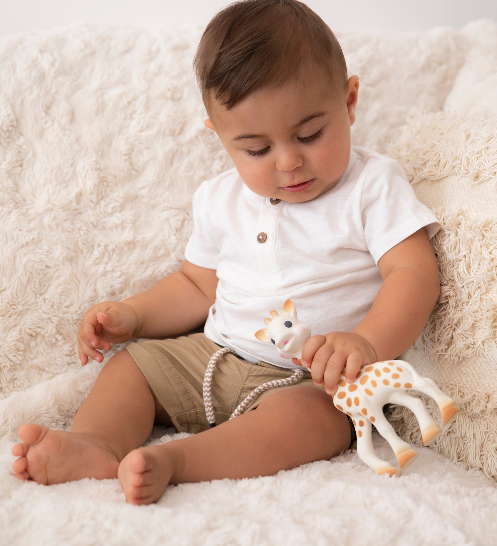  smiling giraffe teether on a cream background