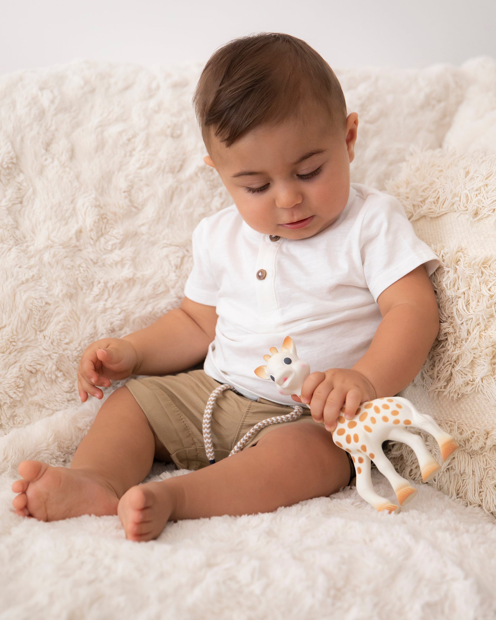  smiling giraffe teether on a cream background