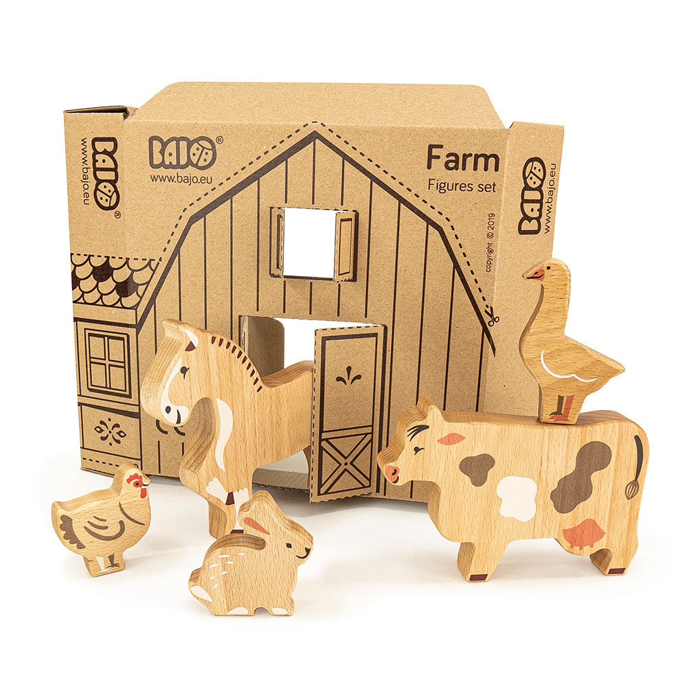 Bajo plastic-free wooden farm animal figures stood on a white background next to their cardboard box