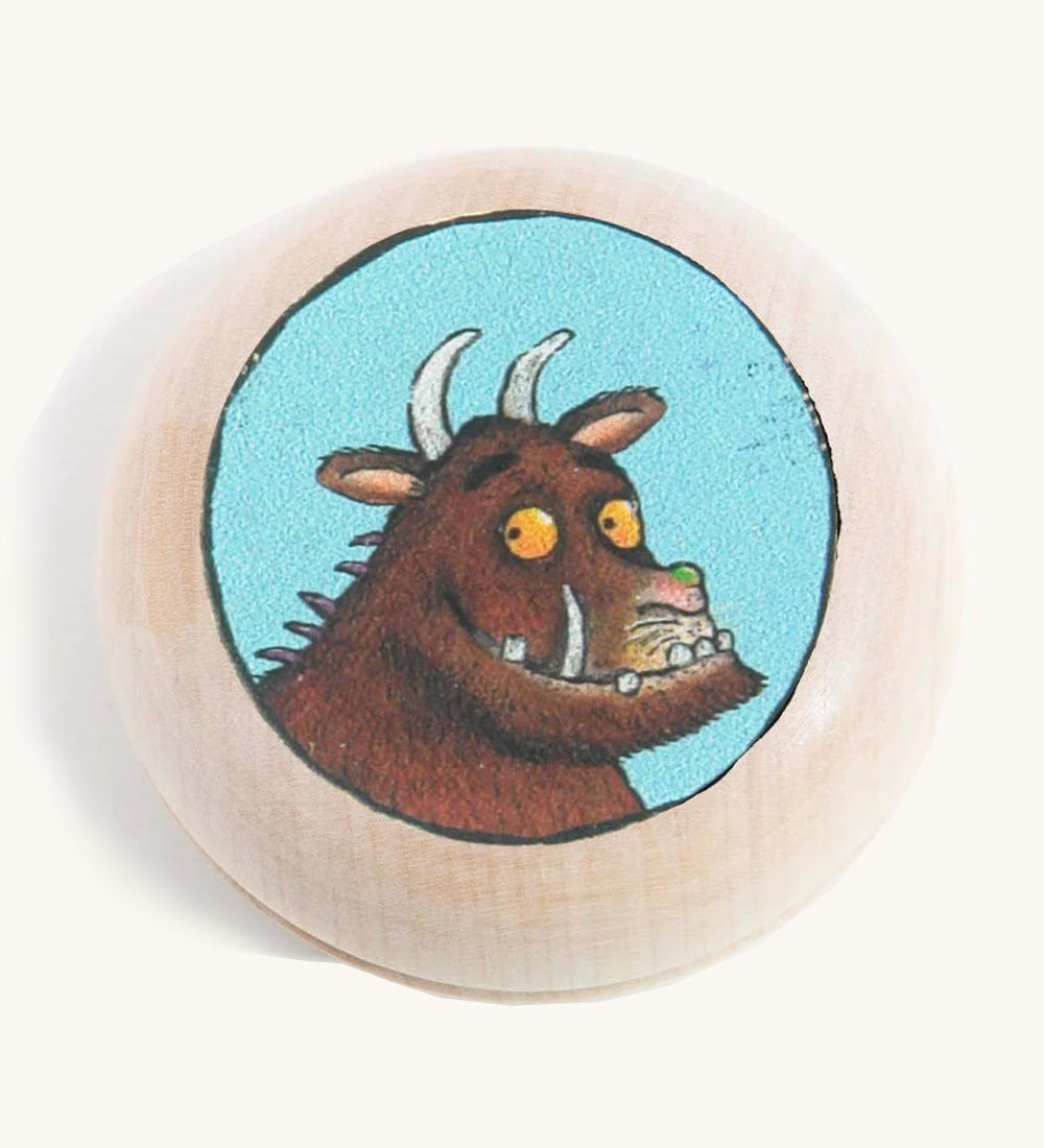 A wooden gruffalo magnet on a cream background