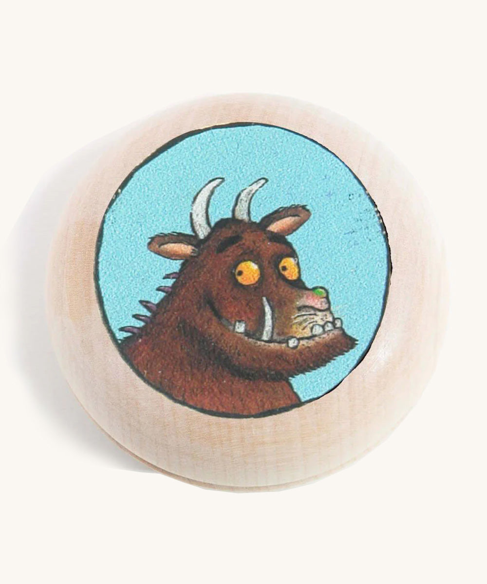 A wooden gruffalo magnet on a cream background