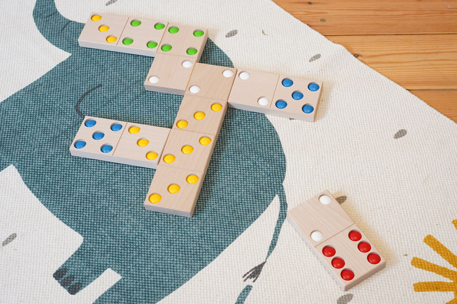 Bajo children's XXL wooden dominos game laid out on a blue and white carpet