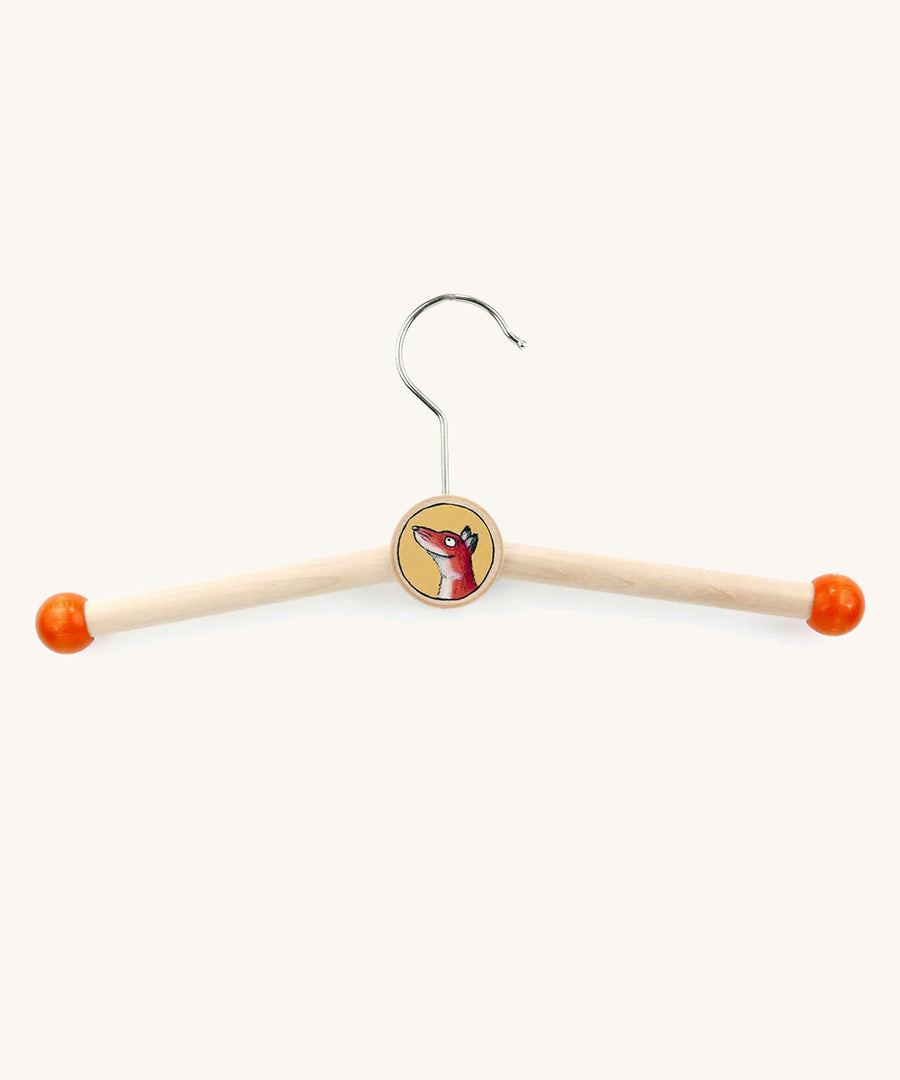 A wooden fox gruffalo character kids hanger on a cream backround