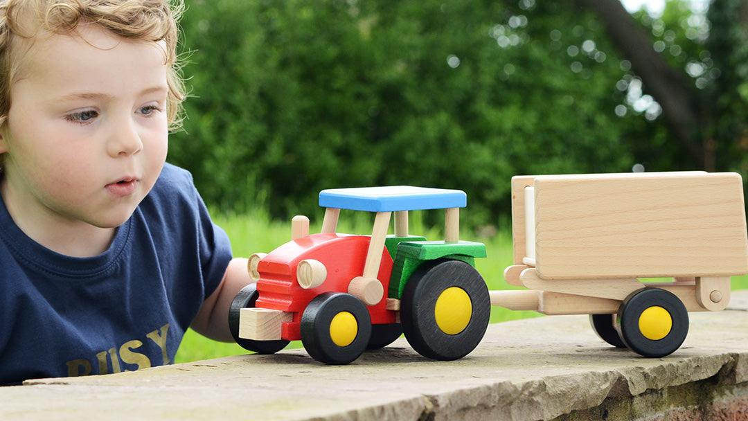 Child playing with a Bajo tractor