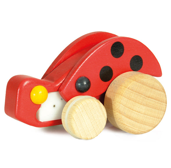 The Bajo Pull-Back Ladybird has natural wood wheels