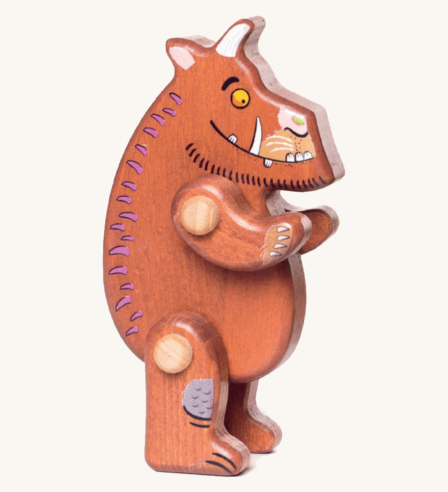 A wooden standing Gruffalo figure on a cream background